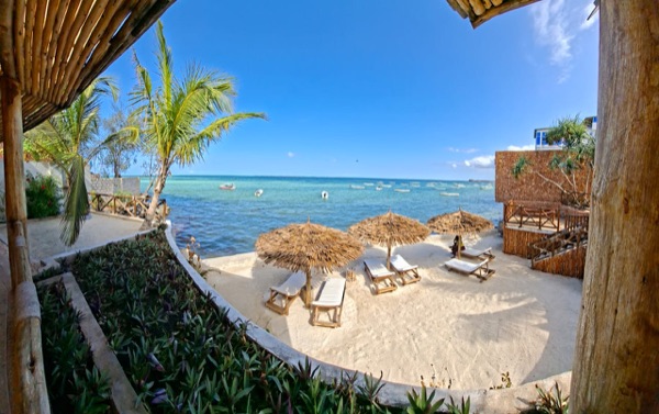 Private beach seen through bamboo arch