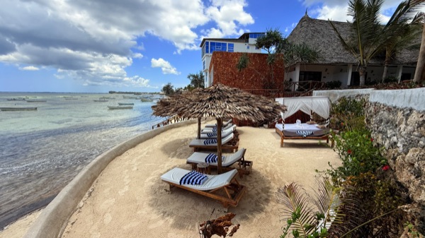 Hotel beachfront with sunbeds and ocean